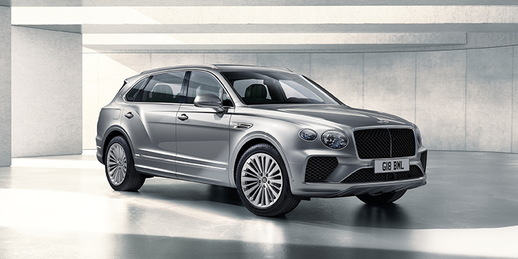 Bentley Stockholm Bentley Bentayga Extended Wheelbase SUV front three quarter in Moonbeam paint with a grey background