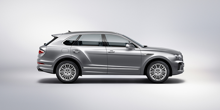 Bentley Stockholm Bentley Bentayga SUV side profile in Moonbeam silver paint against white background featuring 21 inch 5 spoke wheels