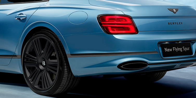 Bentley Stockholm New Bentley Flying Spur Azure sedan in Light windsor blue by Mulliner paint and Black Specification, showing 22 inch Black Azure wheel, black exhaust pipes and exterior features